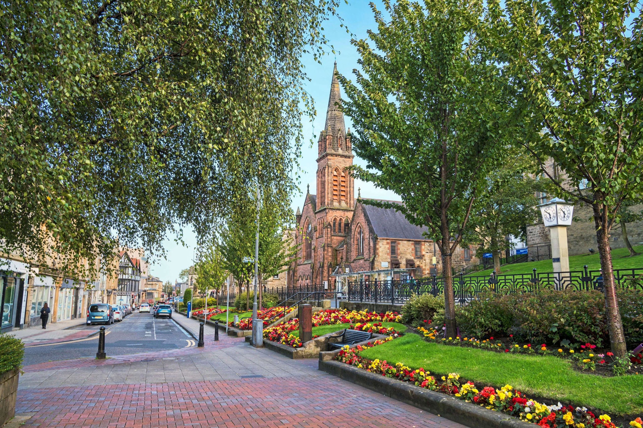 Beautiful flower displays on Newmarket Street in Falkirk with church in the background.